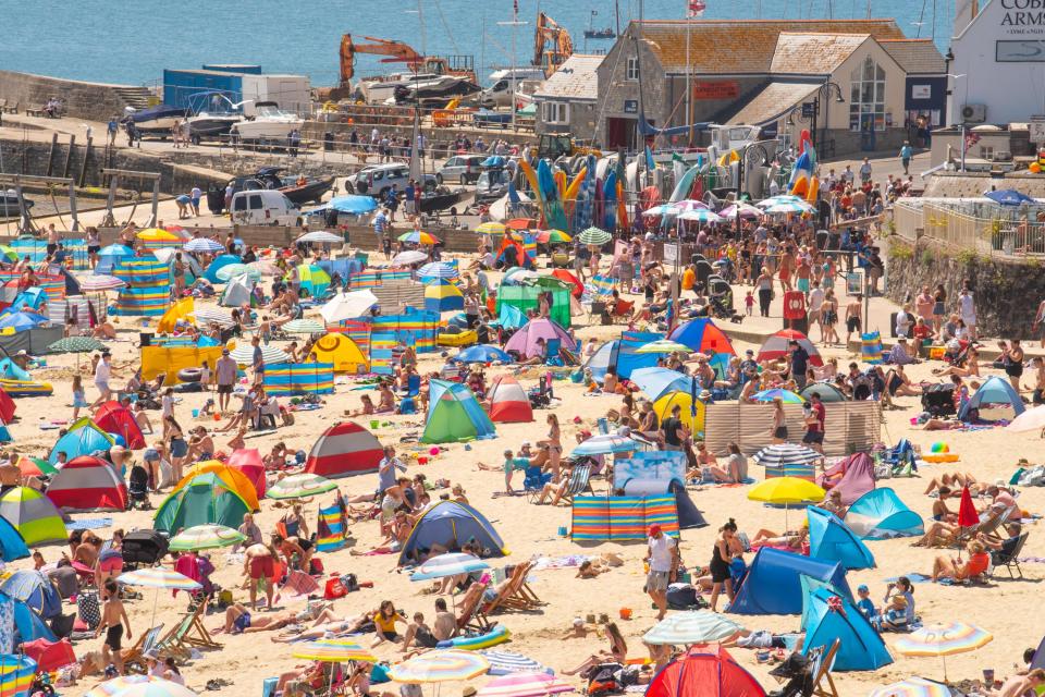  Brits take to the beach in Lyme Regis, Dorset as temperatures continue to sizzle across the country