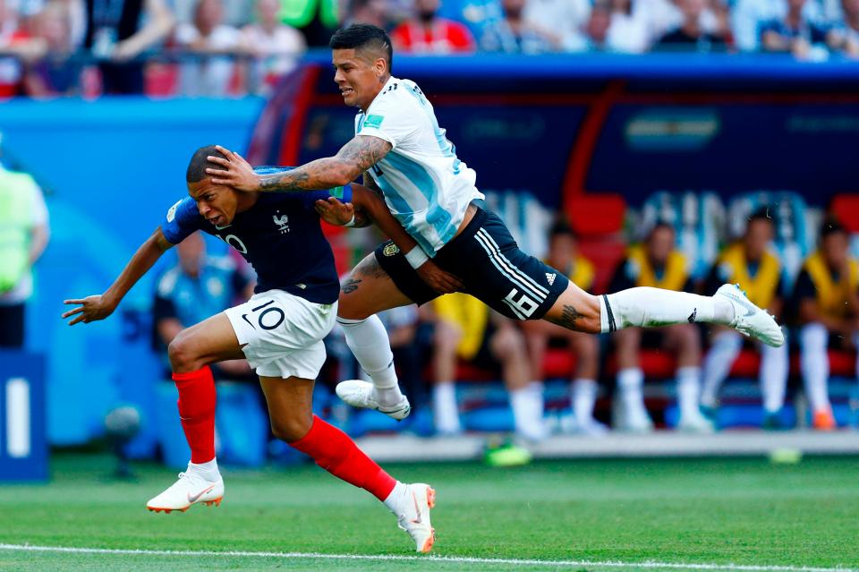 Kylian Mbappe breaks into the box at the end of his run, leading to Marcos Rojo conceding a spot-kick by bringing them both tumbling down