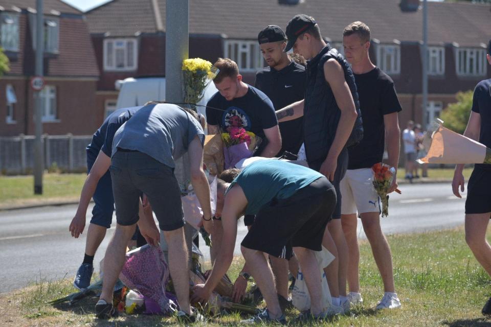  Friends of the victims lay flowers at the scene of the horror smash in Leeds