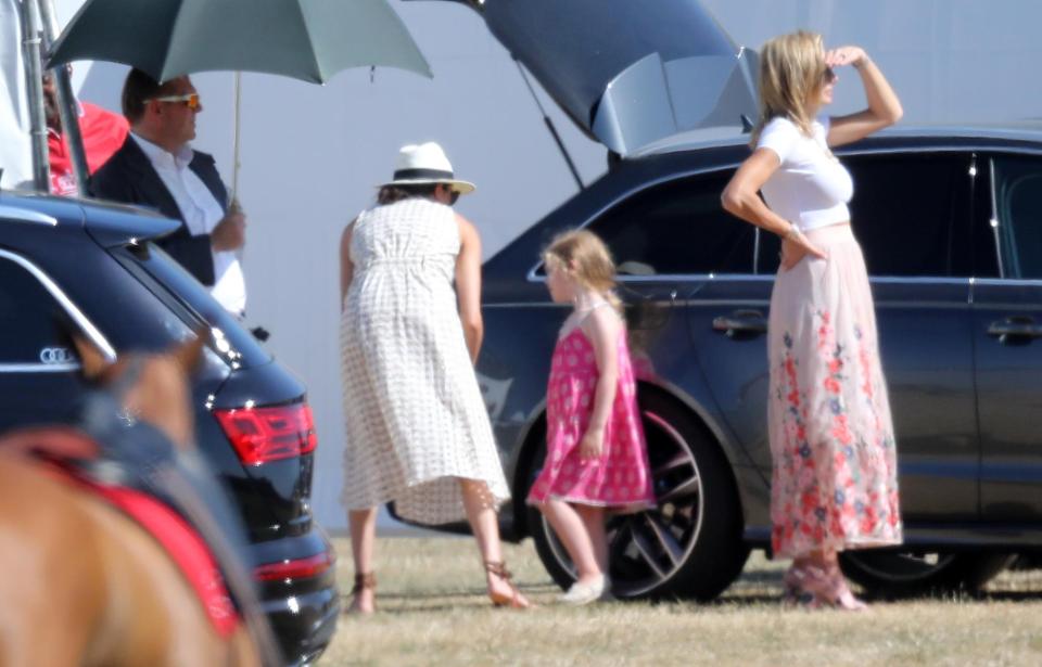  Meghan paired her dress with a white hat, and lace-up sandals