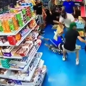  Lesandro Guzman-Feliz is shown being dragged out of the Bronx shop