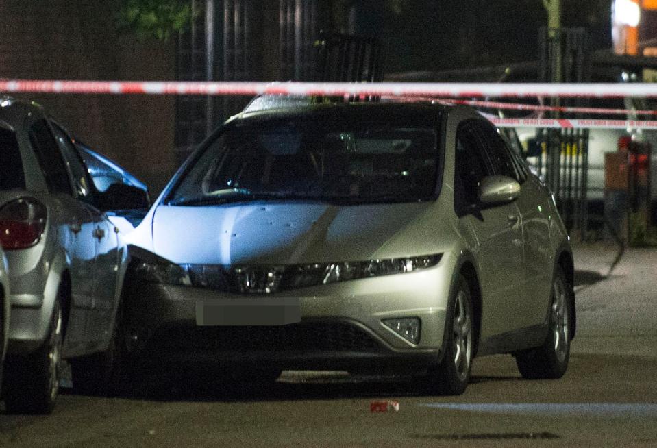 A badly damaged car was riddled with bullets in Brent, with one man left seriously injured