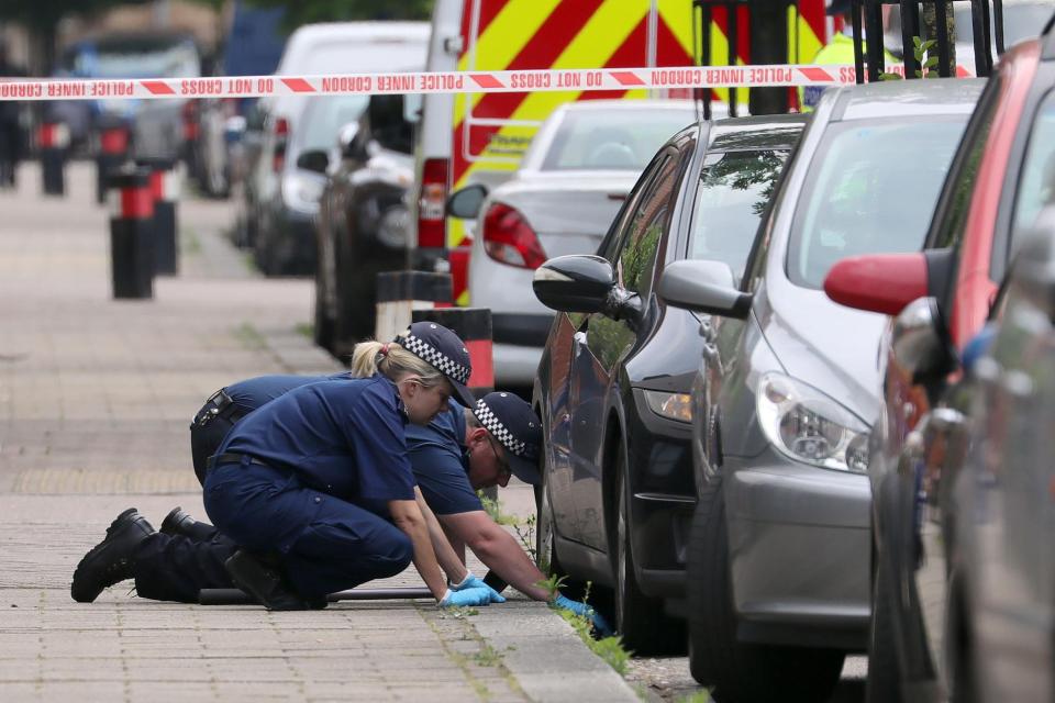 Police officers examined the area around Brent after the man in his 20s was gunned down