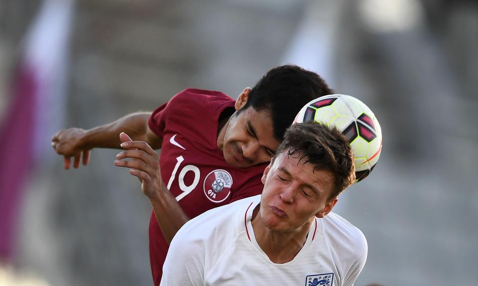 England's Dael Fry challenges Qatars Maurice Revello for the ball