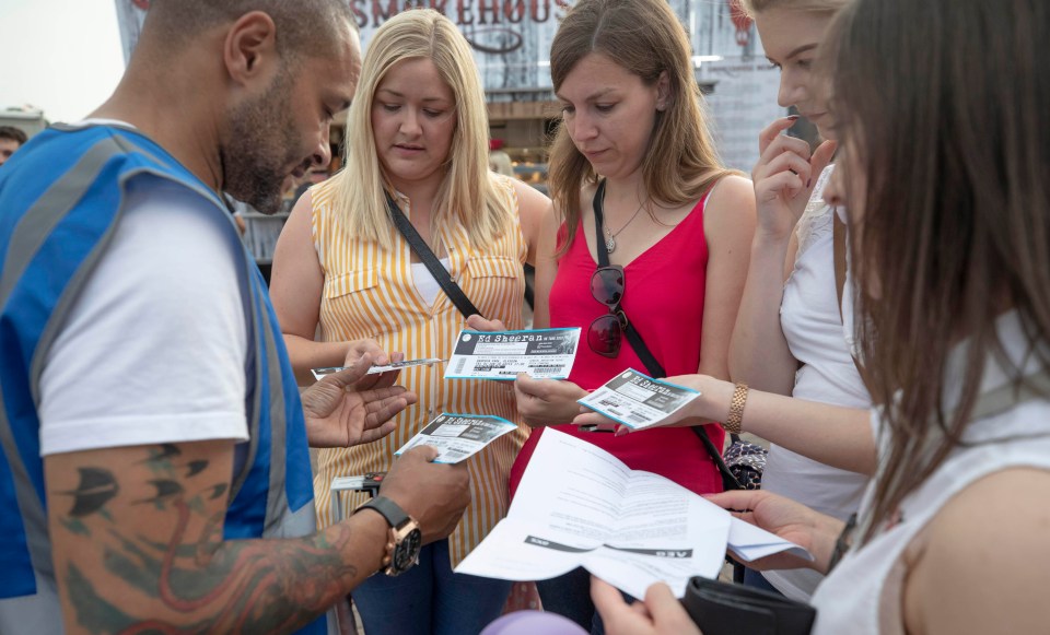 A ticket inspector checks fans at Ed Sheeran’s Glasgow gig