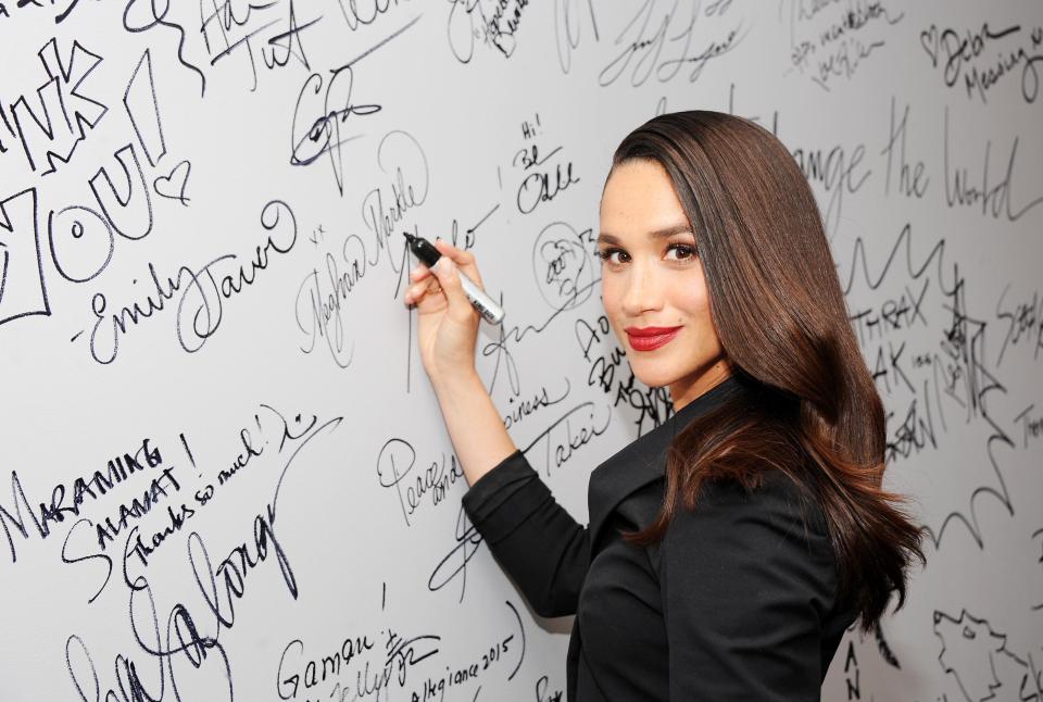  Meghan signs a wall at AOL studios in 2016