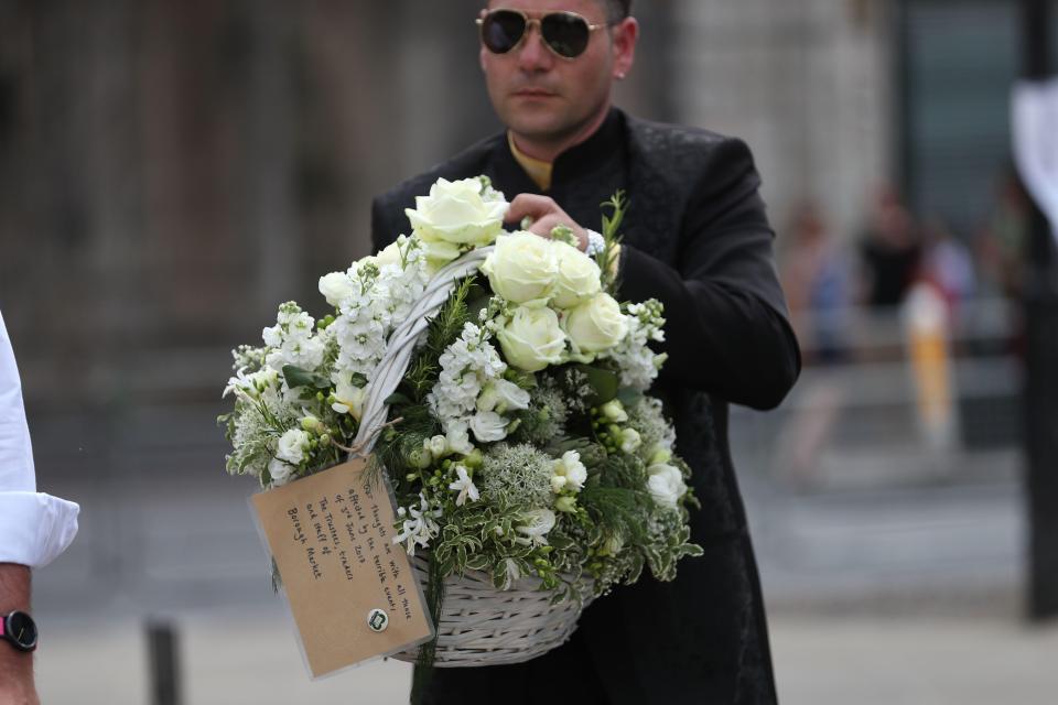  A man carries floral tributes from Borough Market to London Bridge ahead of the remembrance service