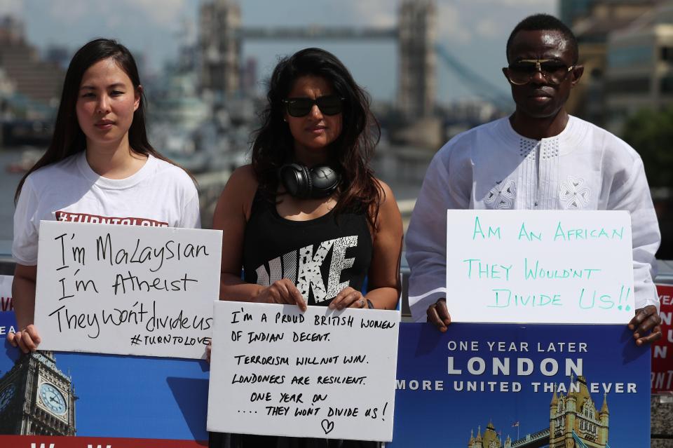  People of all faiths and nationalities hold placards as they gather on London Bridge to give a strong show of unity