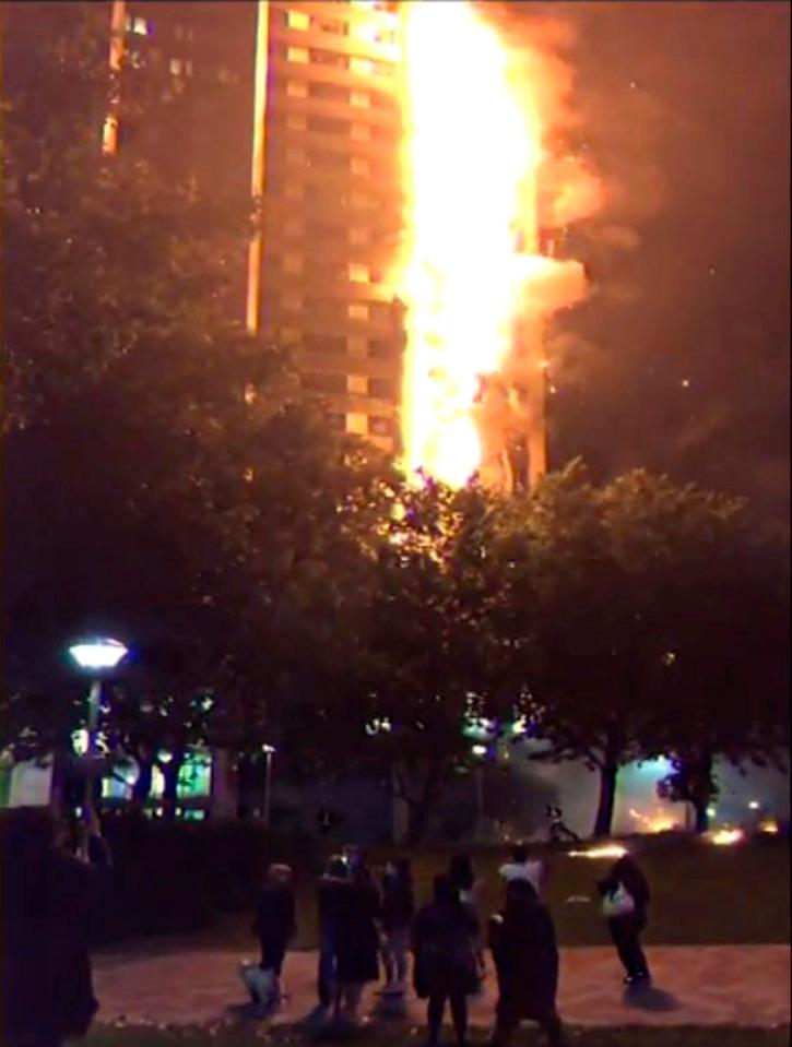  Onlookers gaze in horror as by 1.26am the fire had spread through most of the building