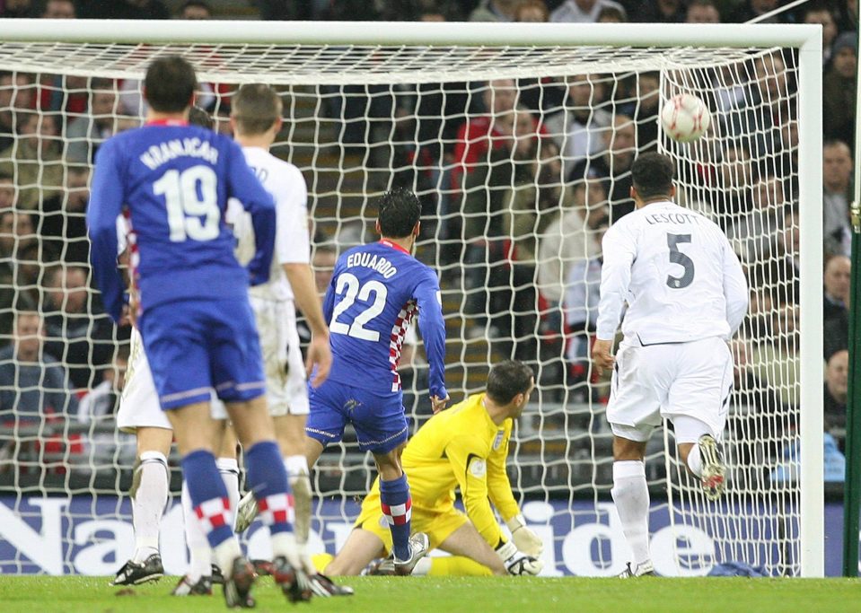  Scott Carson watches in agony as the ball squirms from his grasp into the net