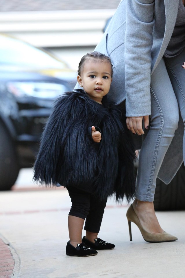 North in a furry cape and designer shoes