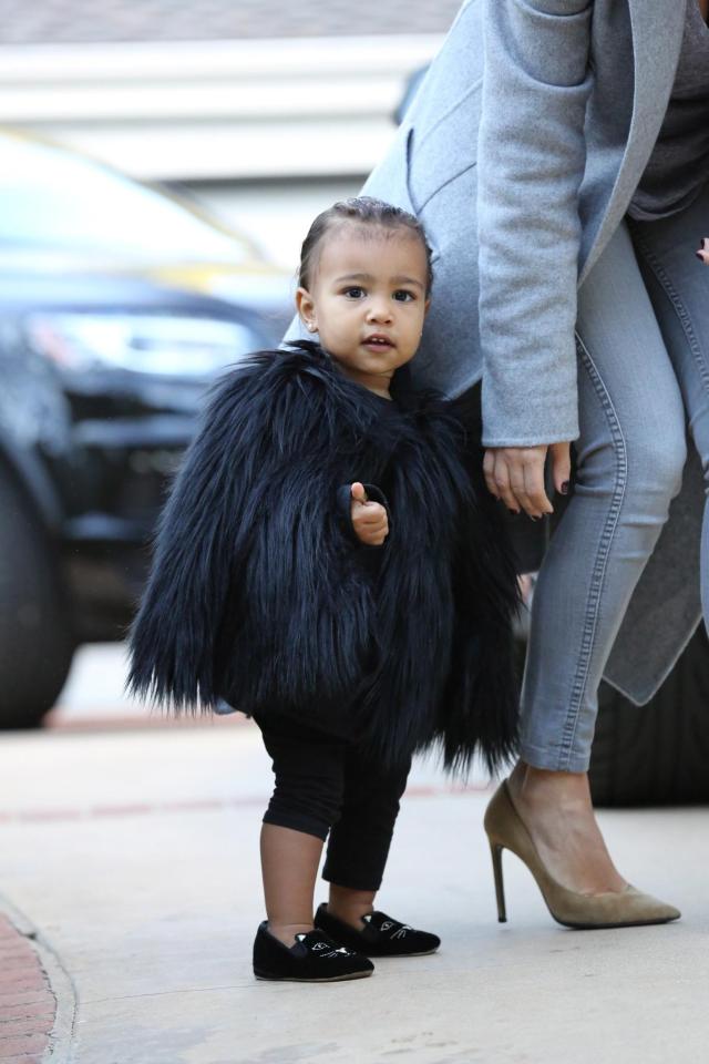  North in a furry cape and designer shoes