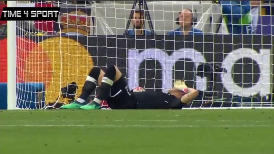  Karius lies on the ground after seemingly taking a blow to the head