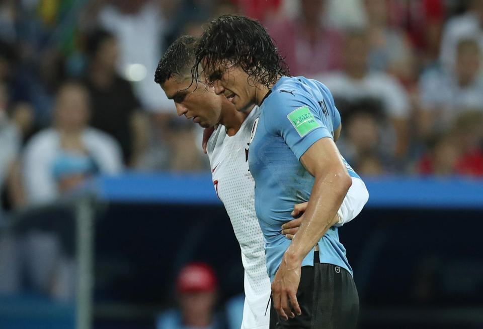  Cristiano Ronaldo helped Edinson Cavani off the pitch as Uruguay beat Portugal 2-1