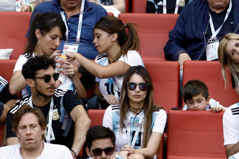 Antonella Roccuzzo checks on son Mateo while Thiago rests against a chair