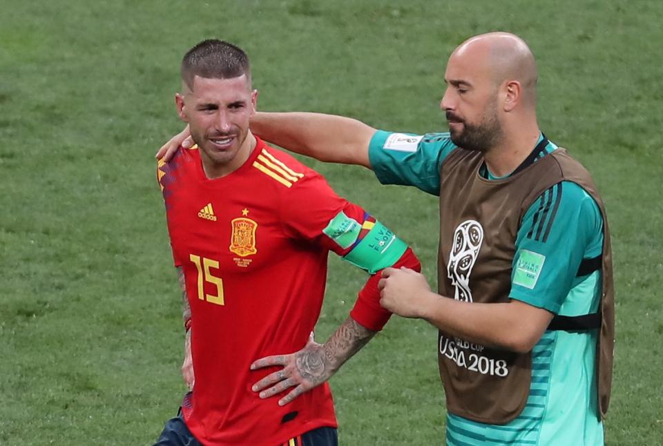  Pepe Reina consoles Sergio Ramos after Spain's defeat against Russia