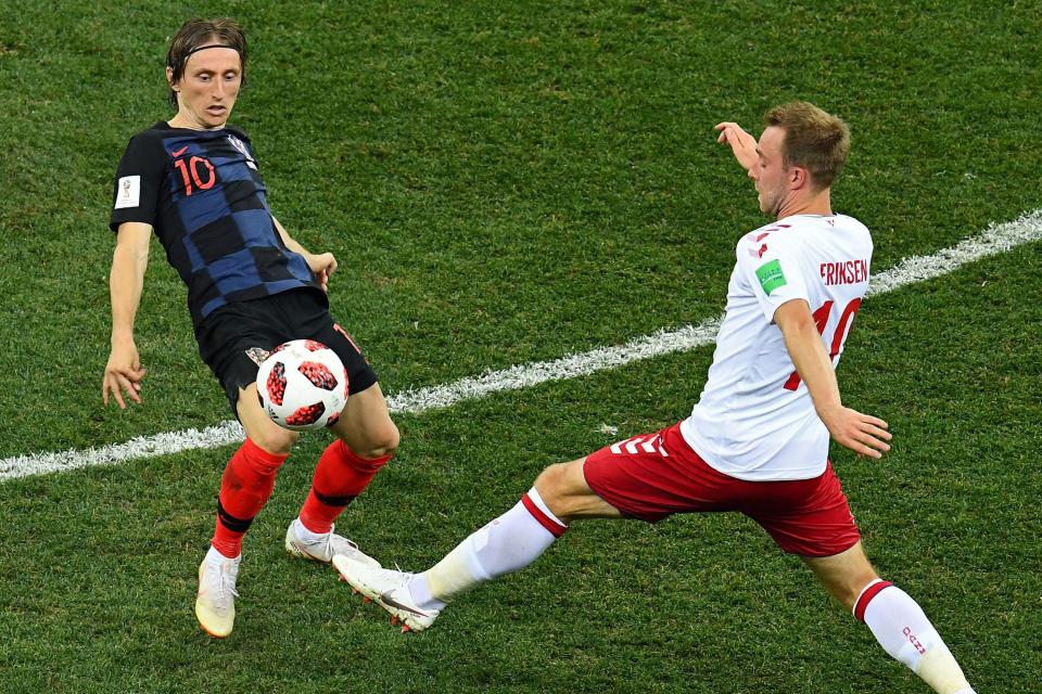  Star men Luka Modric and Christien Eriksen vie for the ball in midfield