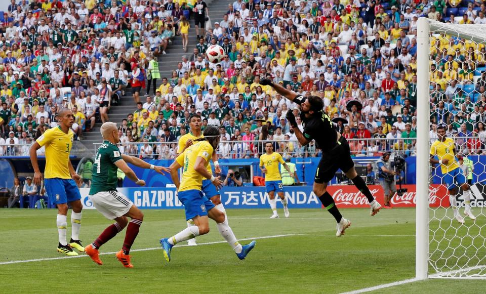  Alisson leaps to make an acrobatic save in the first half