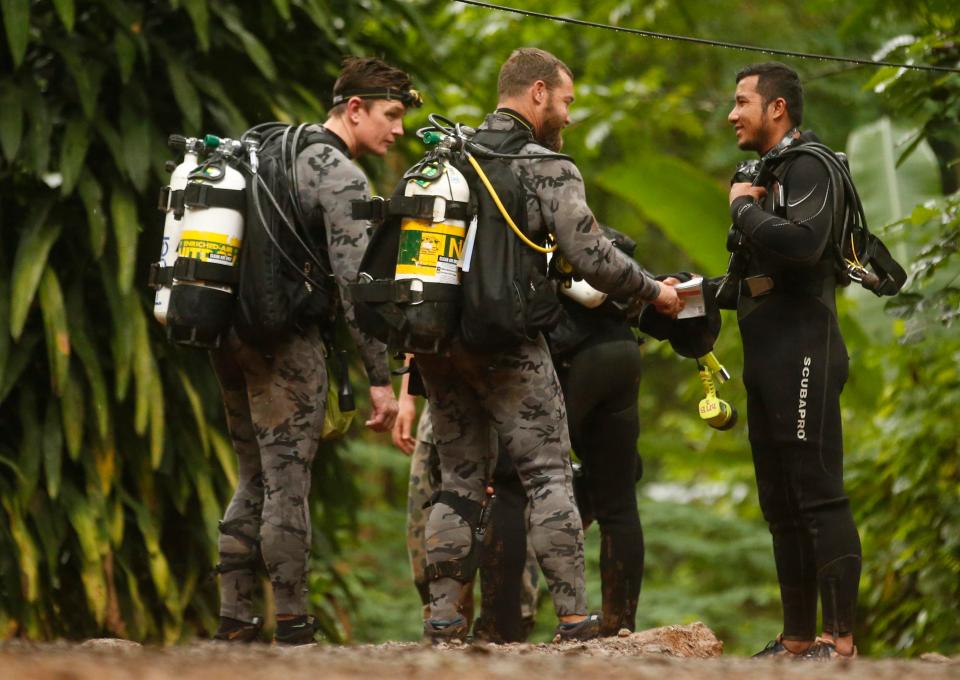  Australian Federal Police and Defence Force personnel speak with a Thai rescuer