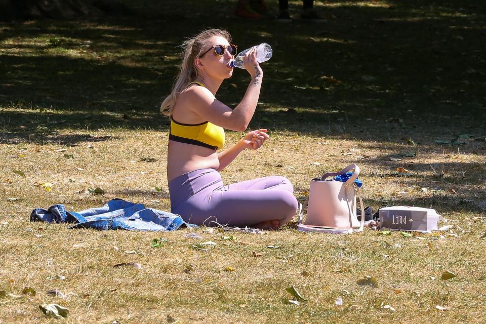  This woman soaks up the sun in Green Park, London