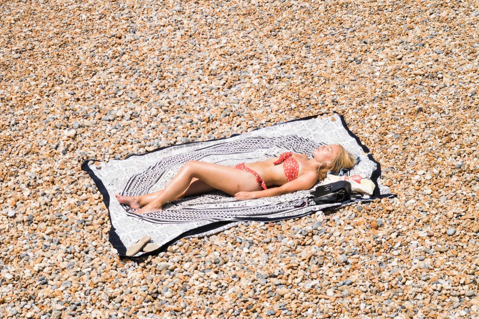  Crowds have been flocking to the coast, like this woman on Brighton beach