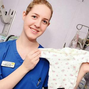  Lucy Letby posed on a ward holding a babygro and described her love of the job