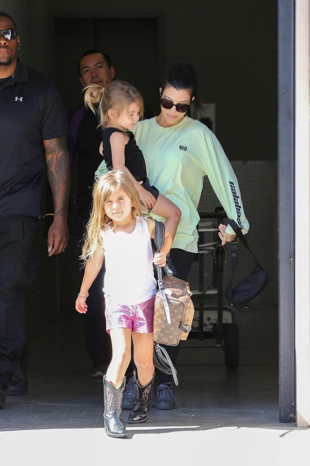  Penelope carries a Louis Vuitton backpack