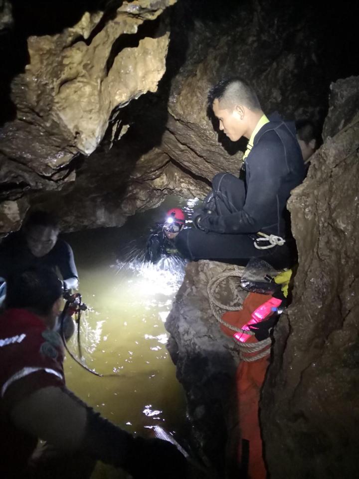  Divers plunged into the dark waters of the flooded cave in Thailand where 12 boys were trapped