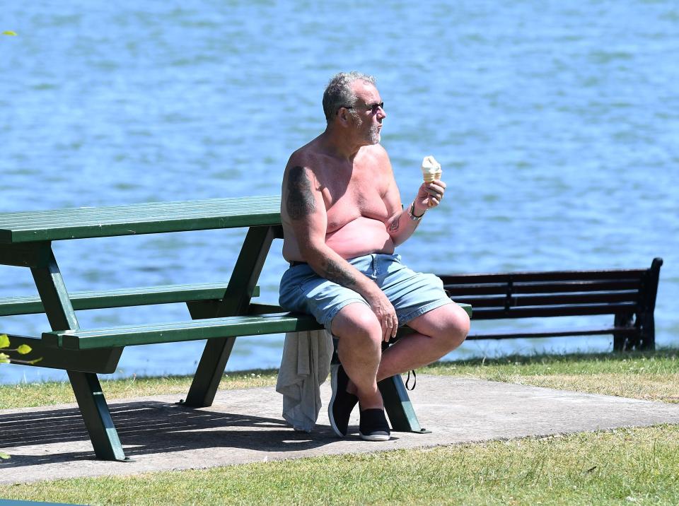  This man in Belfast enjoys an ice cream in the heat