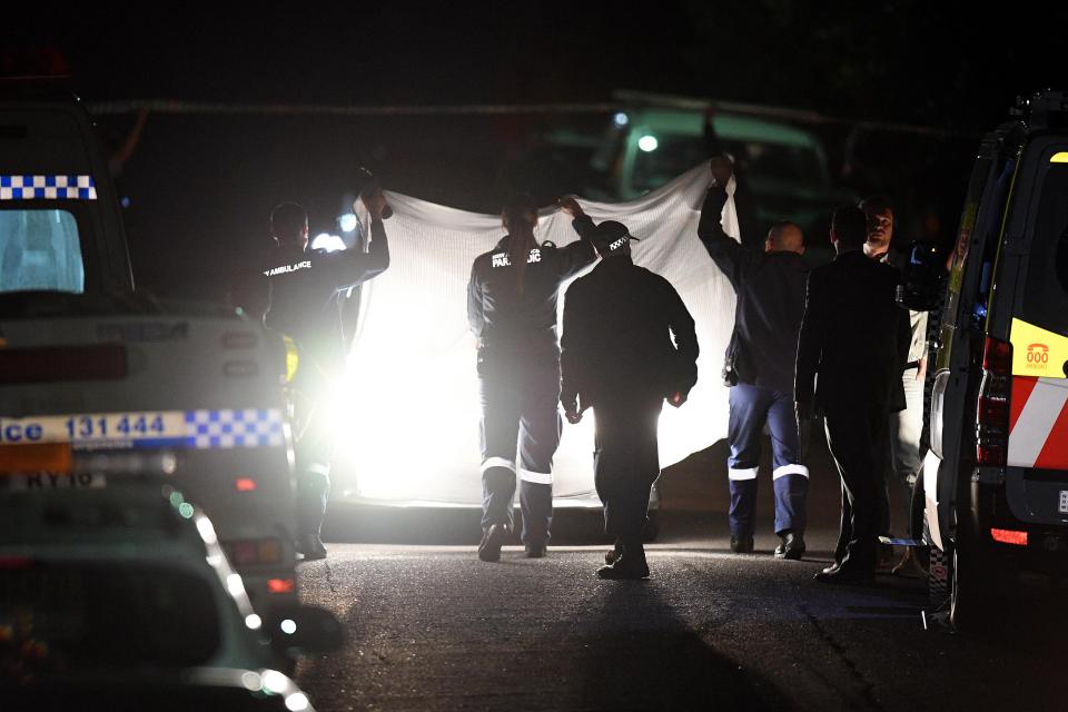  Police search the scene where the teenagers were shot