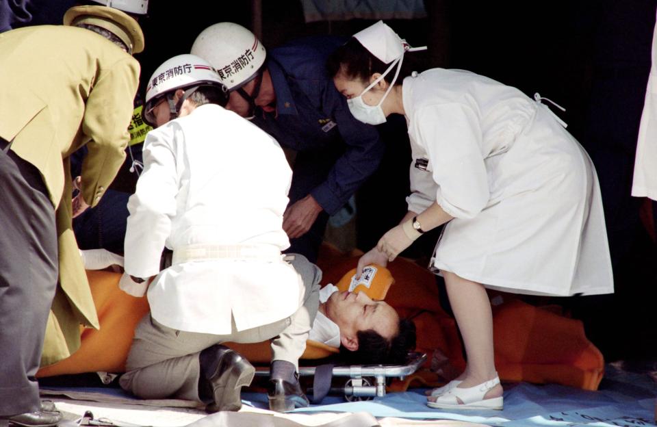  A commuter being treated by an emergency medical team at a make-shift shelter before being transported to hospital