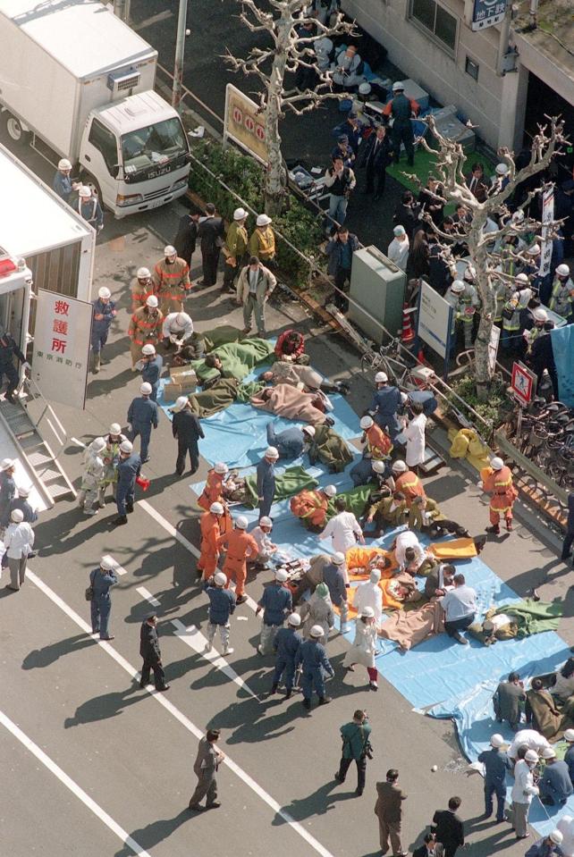  The injured of the deadly gas attack are treated by rescue workers near Tsukiji subway station in Tokyo