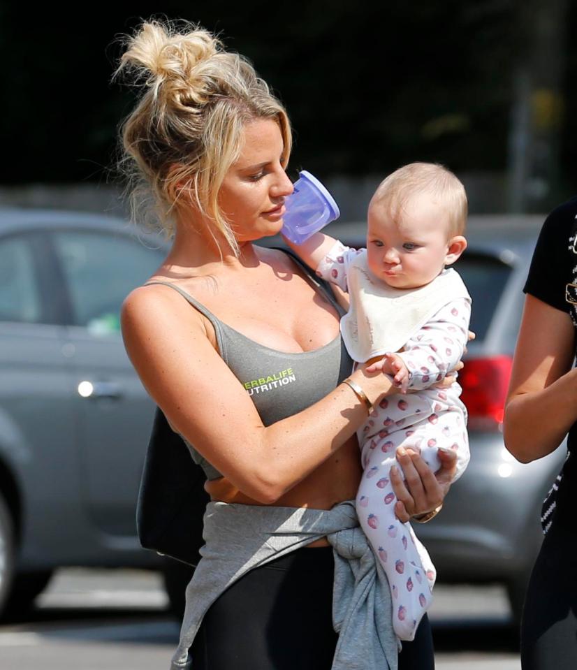  Danielle kept baby Sunday close to her chest as she took a stroll in Essex yesterday