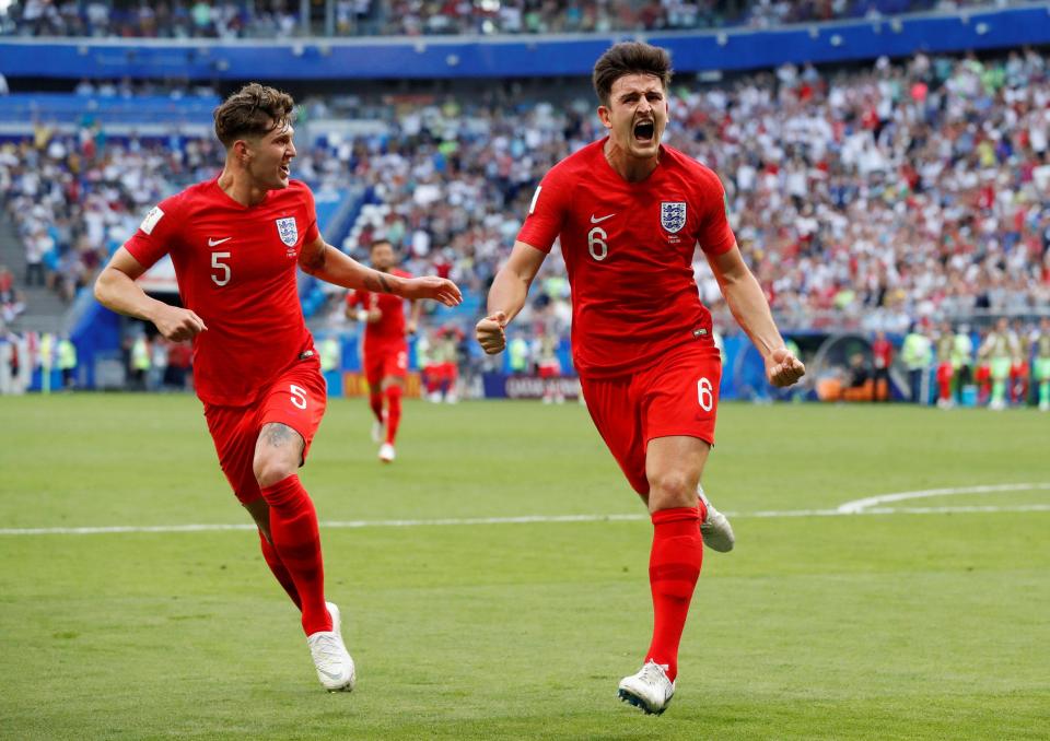  Harry Maguire is chased by John Stones as the celebrations after his goal begin