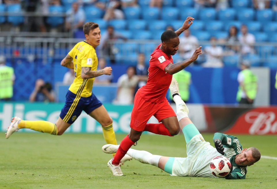  Sweden keeper Robin Olsen gets down to deny Raheem Sterling as England swarm all over their rivals