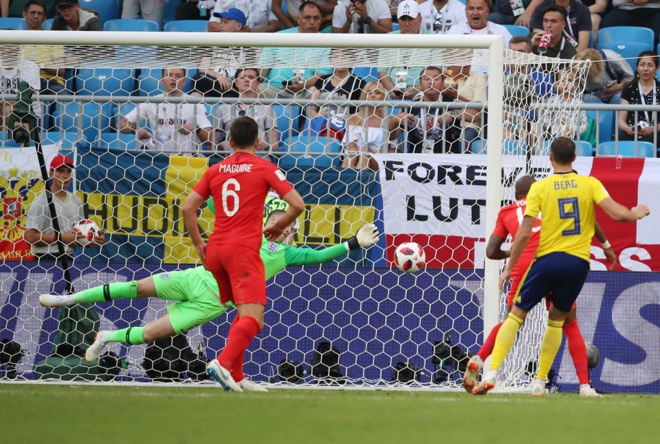  Jordan Pickford flings himself to his left to keep out a header from Marcus Berg to deny Sweden an equaliser