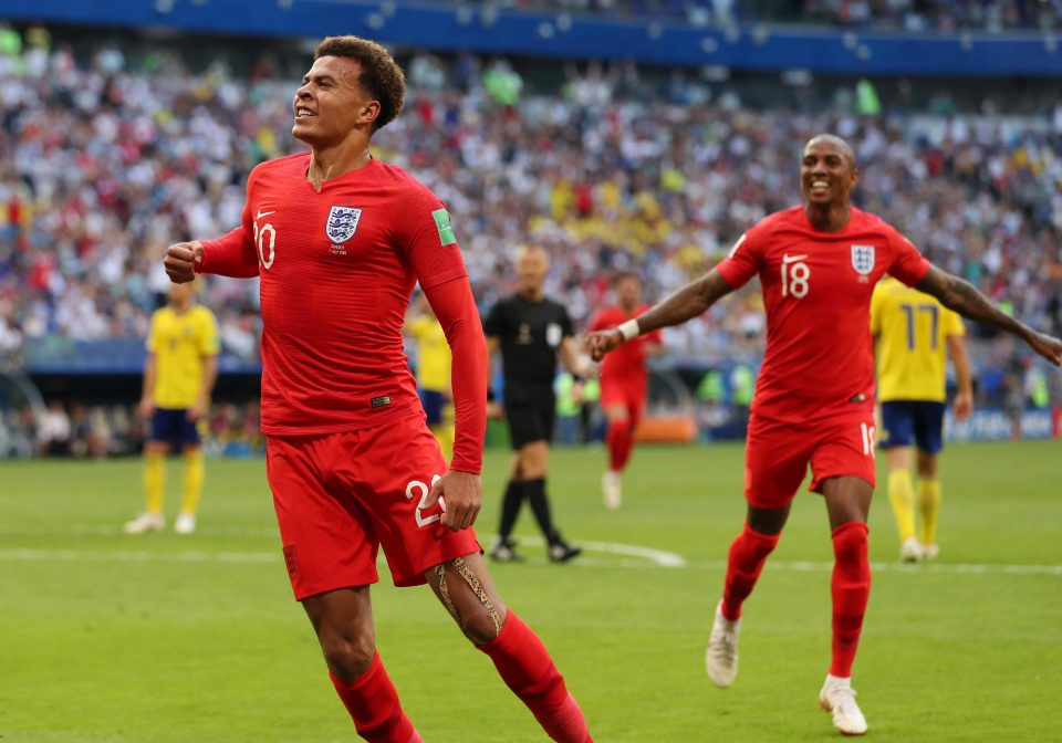  Dele Alli celebrates with the crowd as Ashley Young trots over to join him