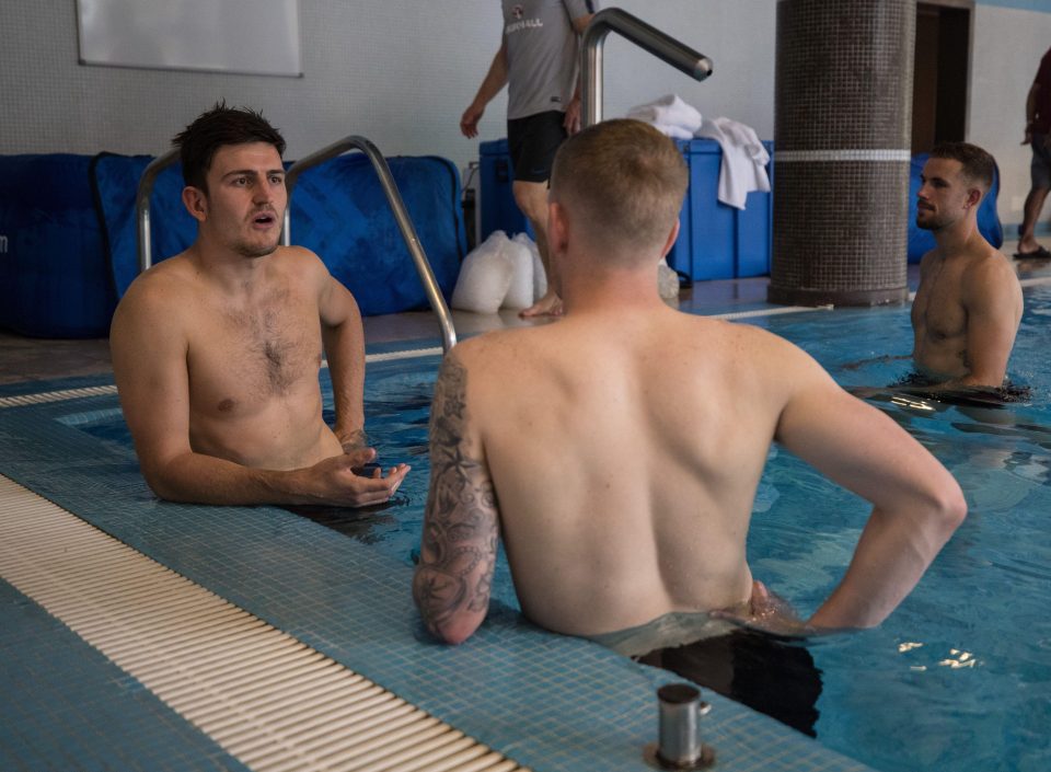  Harry Maguire and Jordan Pickford have a chat on the side of the pool during a light day of recovery for the England squad