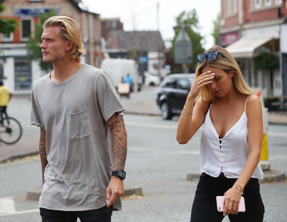  Daniella Grace covers her face as she walks alongside Loris Karius