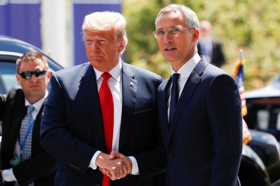  Trump pictured shaking hands with Stoltenberg following their tense meeting this morning