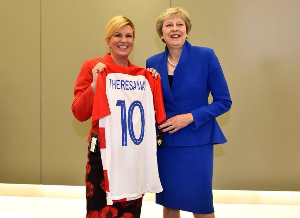  Croatia’s President Kolinda Grabar-Kitarovic presents Theresa May with a shirt ahead of the crunch clash tonight