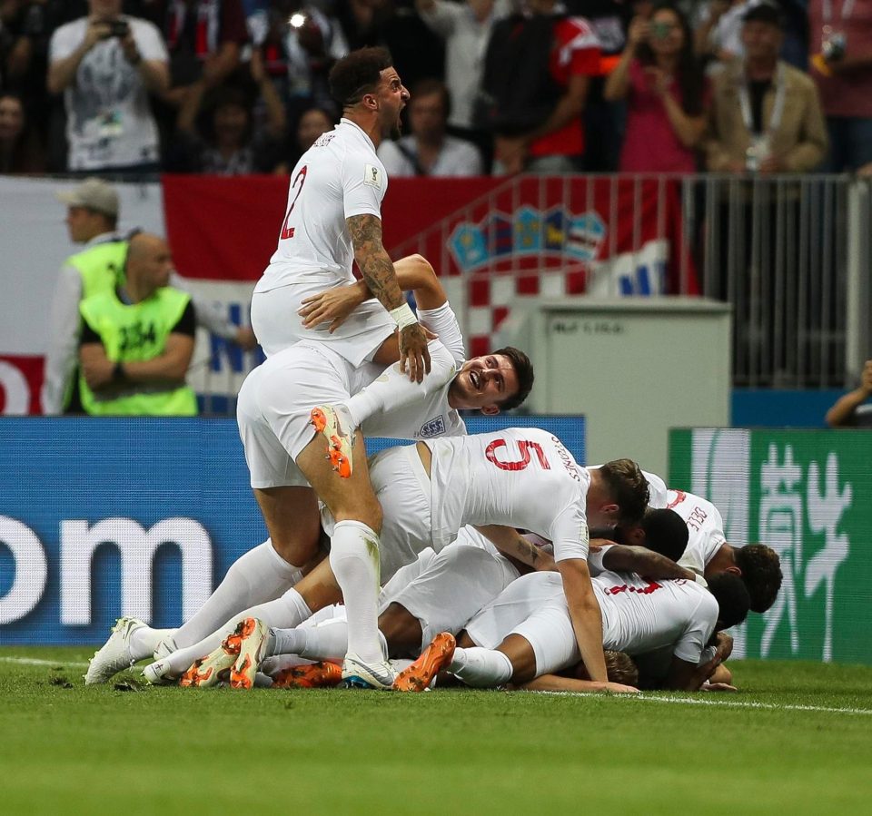 The England players pile on top of Trippier as they savour taking the lead in the World Cup semi-final