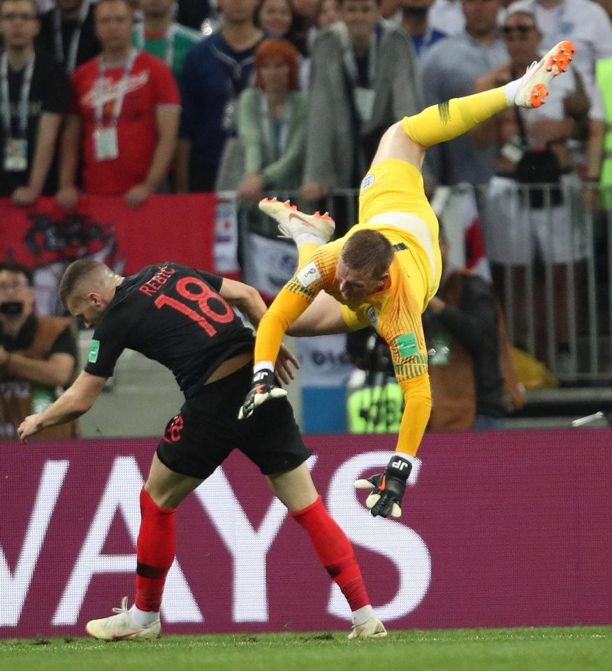 Jordan Pickford is sent tumbling under the challenge of Ante Rebic