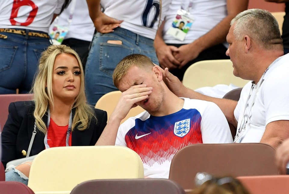 Jordan Pickford holds his head in his hands with his partner Megan Davison and family 