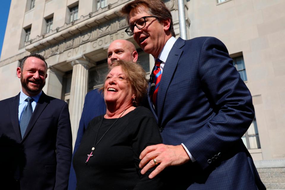  Plaintiff Gail Ingham stands outside the courthouse in St Louis, Missouri, with attorneys Lee Cirsch, from left, Eric Holland and Mark Lanier following the verdict against Johnson & Johnson