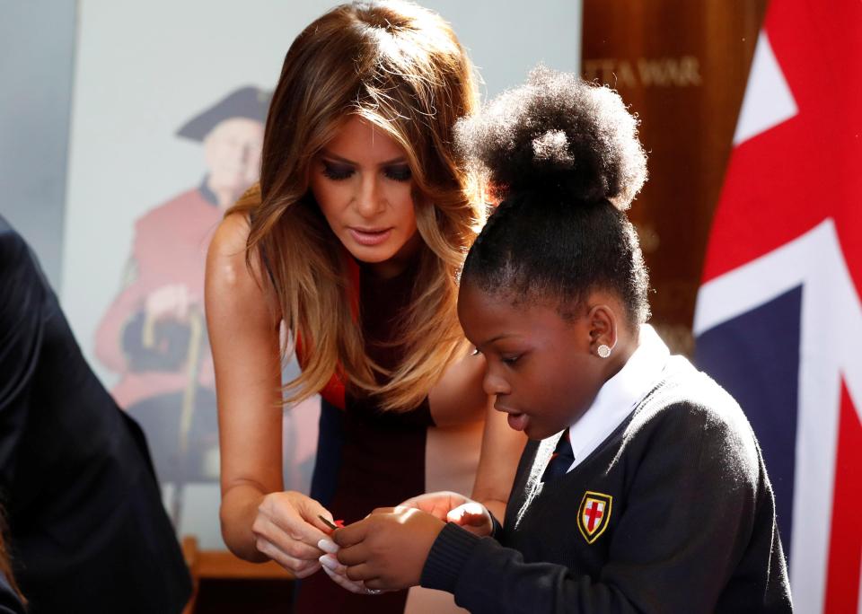  Melania appeared to be striking up a friendship with one of the girls as they made the poppies together