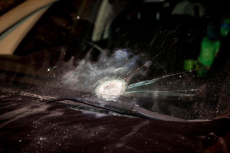  Adams said no one was hurt in the incident but Sinn Féin said one of the devices damaged a car (pictured)