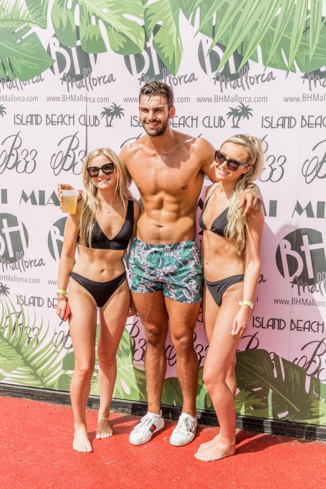  Adam, at the first of 61 PAs in Mallorca posing with female revellers, boasts women 'throw themselves' at him