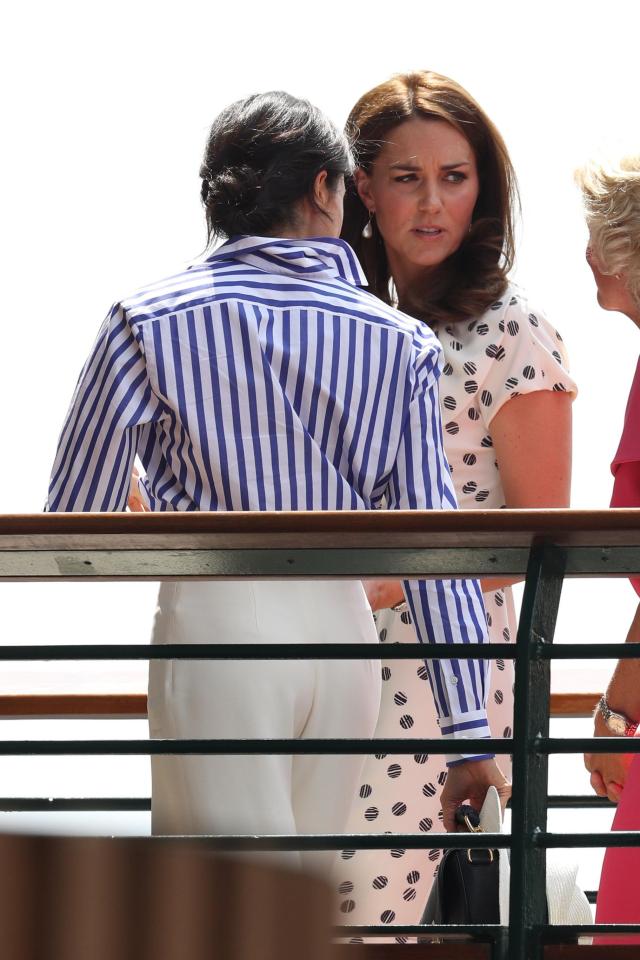  Meghan exuded Wimbledon chic with a loose-fitted blue and white striped shirt