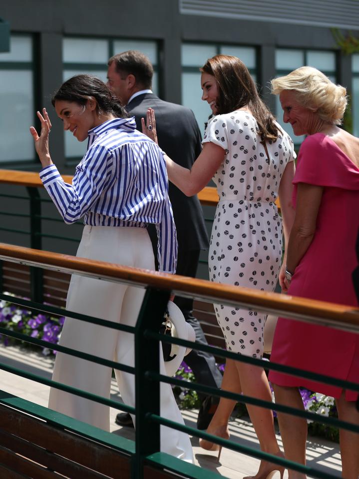  Chairman of the AELTC Philip Brook and his wife Gill walk across a bridge with the Duchess of Cambridge